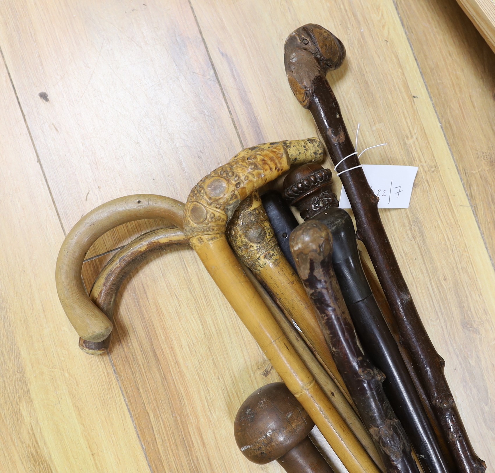 Nine assorted walking sticks and canes and a knobkerrie